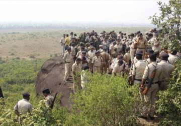 Police personnel at the encounter site at the hillocks of Acharpura village.
