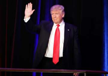 Donald Trump waves hand to his supporters at victory rally in New York.