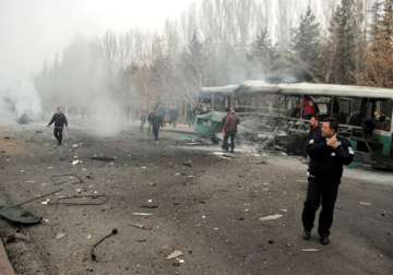 Security officials at the scene of a car bomb attack in Kayseri