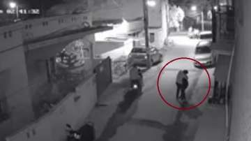 Two scooter-borne men were caught on security camera when they groped a woman