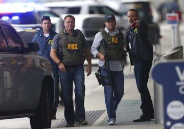 FBI officers work the scene at Fort Lauderdale-Hollywood International Airport