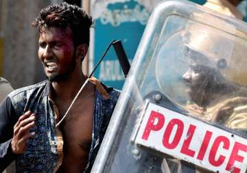 Police take away one of the pro-Jallikattu protesters during a clash