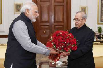 President Mukherjee being greeted by PM Modi on New Year
