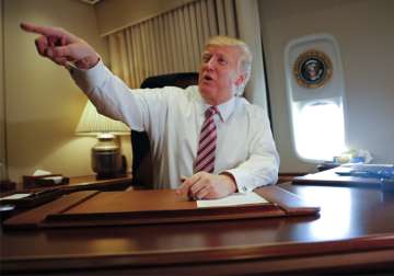 Donald Trump at his desk on Air Force One

