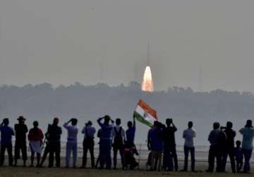 People watch as an ISRO rocket takes off successfully to launch 104 satellites