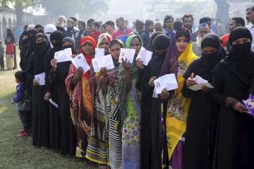 Voters in Lakhimpur Kheri queue up to cast vote at a polling station