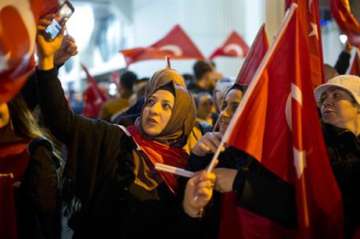 Demonstrators wave turkish flags outside the Turkish consulate in Rotterdam