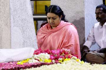 Deepa Jayakumar sitting in a meditation in front of Jayalalithaa's burial site