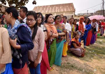Voters stand in queues at a polling center to cast their votes in Manipur