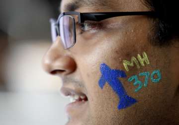 File pic - A man with a painted face attend Day of Remembrance for MH370 event
