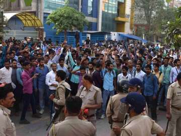 Oppo employees protest outside the assembling unit of company in Noida 