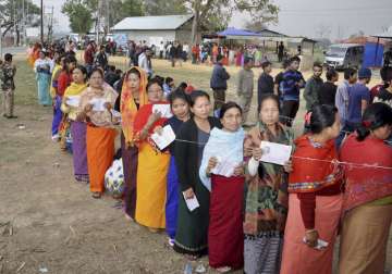 Voters stand in queues at a polling center to cast their votes in Manipur