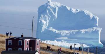 A 150-feet iceberg floats past Canadian village
