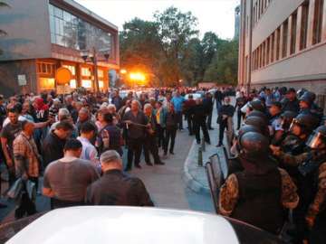 Police block protestors from entering into the Parliament building in Skopje