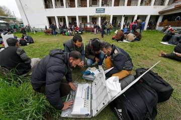 Polling staff checking EVMs before heading to polling station in Srinagar