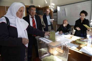 A woman casts a ballot inside a polling station in Istanbul