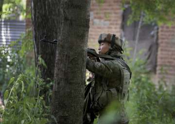 Jawan takes position in a near by house during an encounter at Soimoh
