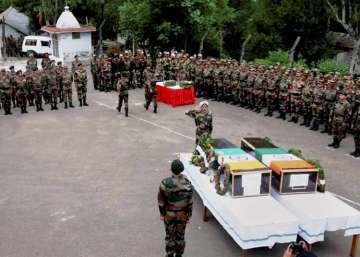 Army official laying wreath on coffins of martyrs Paramjit Singh and Prem Sagar