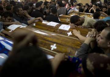 Relatives of Coptic Christians who were killed during a bus attack in Minya