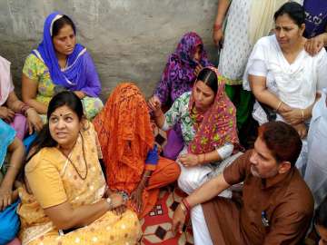Minister Kavita Jain meeting family members of the rape victim at Kalupur
