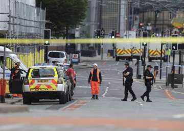 Police guard the Manchester Arena, a day after an explosion