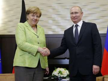 Putin and Merkel shake hands prior to their talks in Sochi