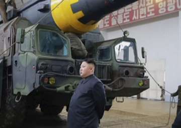 File pic - Kim Jong Un at a missile test site