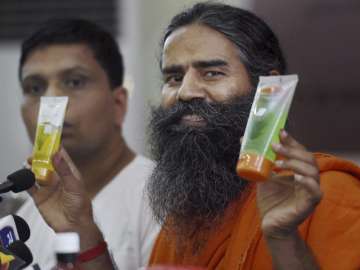Ramdev displays Patanjali's products at its annual press conference in Delhi