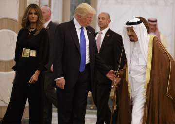 Trump and Melania walk with Saudi King Salman to a coffee ceremony in Riyadh
