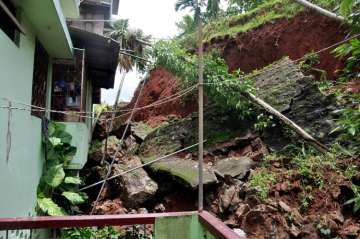 a house damaged due to a landslide triggered by heavy rainfall in Guwahati