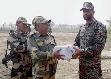 Jammu: BSF personnel exchange sweets with a Pakistan Rangers officer