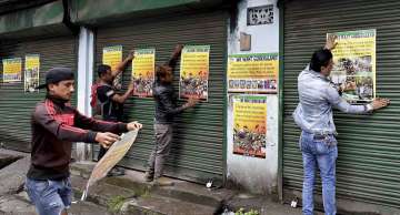 GJM activists paste party posters during indefinite strike