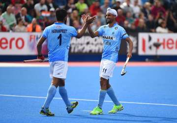 Harmanpreet Singh of India celebrates his goal with Mandeep Singh
