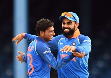 Virat Kohli and Kuldeep Yadav celebrate a dismissal against West Indies.