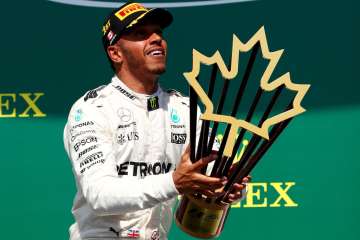 Lewis Hamilton of Great Britain and Mercedes GP celebrates on podium