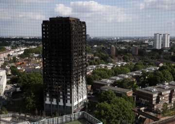 The remains of Grenfell Tower stand in London