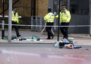 Police patrol nears bags of evidence collected in London Bridge area