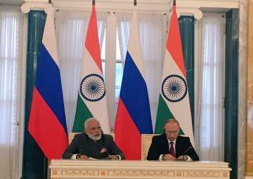 PM Modi and Vladimir Putin at a joint press conference in St Petersburg