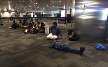 Passengers of cancelled flights wait at Doha Airport