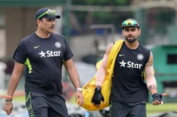  Ravi Shastri (L) and captain Virat Kohli talk during a practice session