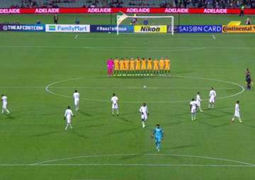 Saudi Arabian players walk on the field during a minute of silence.