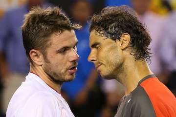 Stanislas Wawrinka of Switzerland and Rafael Nadal of Spain hug at the net