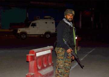Security person stand guard after militants opened fire on the Amarnath Yatra