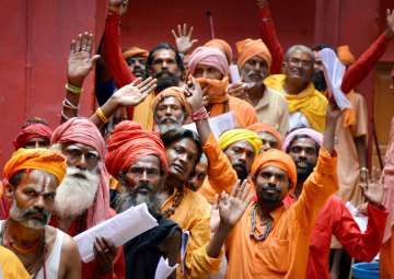 Jammu: Sadhus wait in a queue to register themselves for Amarnath Yatra