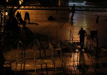 Workers dismantle metal detectors outside the al-Aqsa Mosque compound