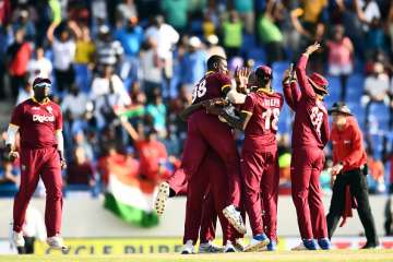 Jason Holder celebrates with teammates after defeating India in Antigua
