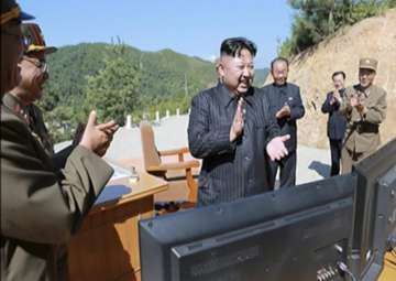 File pic -Kim Jung Un applauding after intercontinental ballistic missile launch