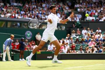 Novak Djokovic of Serbia plays a forehand during the first round