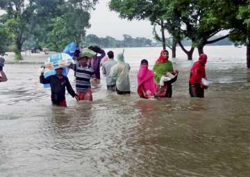 Villagers wade through flood waters in Kishanganj district