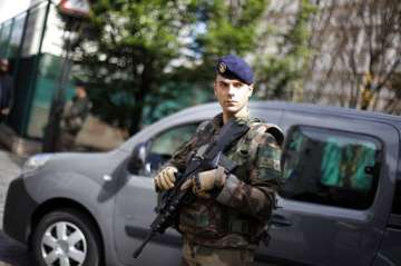 A French soldier stands guard near the site where a vehicle injured six people